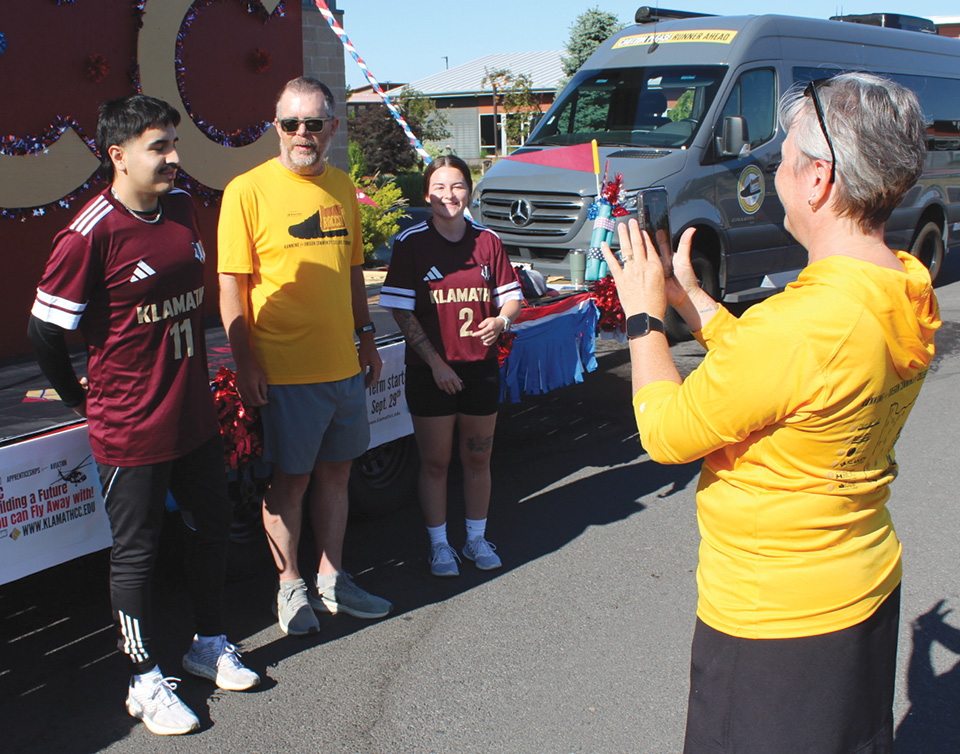 Clackamas Community College President Dr. Tim Cook, center, chats with Klamath Community College students Johan Murillo and Caitlyn Lawrence, while his wife, Paddy, films it for a social media post on Monday, July 7. Dr. Cook is running 1,500 miles across Oregon, visiting 17 community colleges as a fundraiser for students in need.